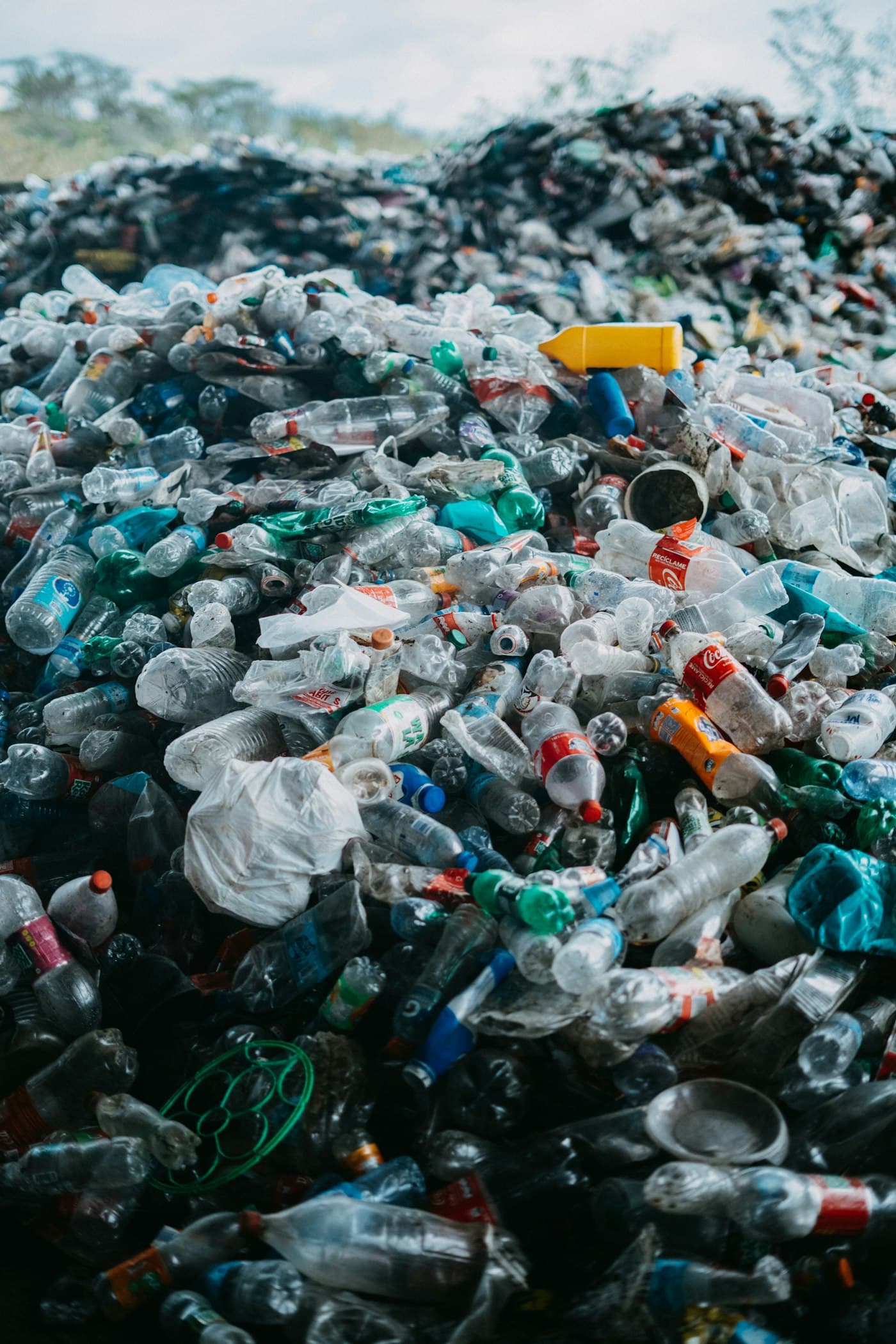 A landfill pile of discarded single-use plastic bottles